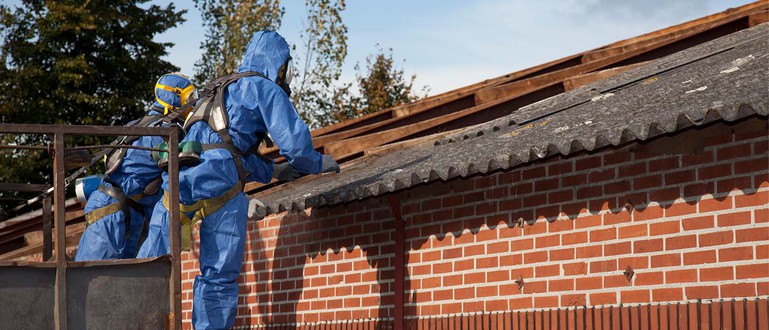 Arbeiter/-innen bei der Asbestsanierung eines Daches